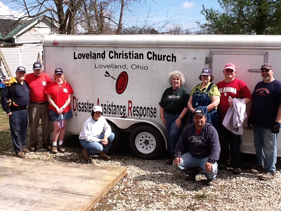 people posing by a truck trailer